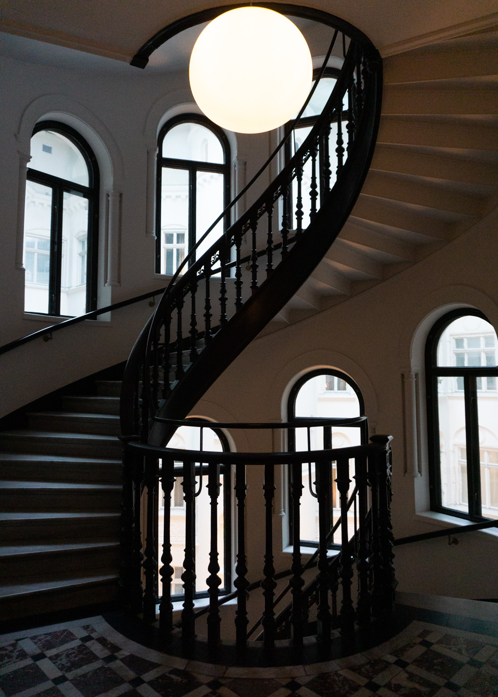 Sculptural staircase and arched windows